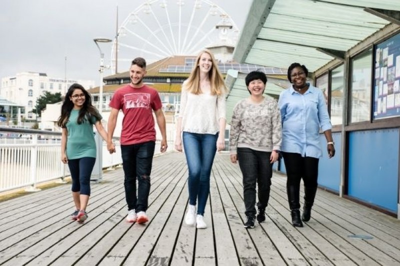 A group of students walking on Bournemouth Pier