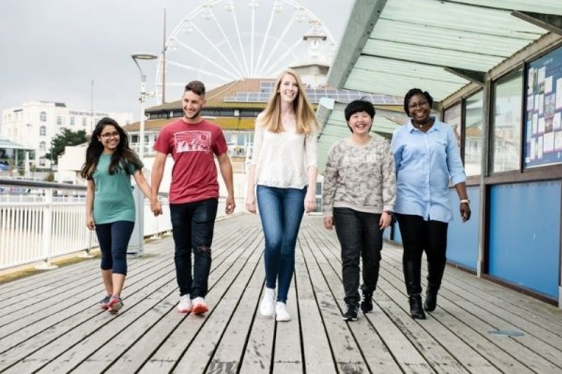 A group of students walking on Bournemouth Pier A group of students walking on Bournemouth Pier