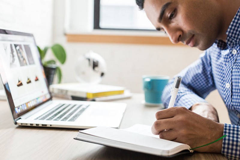 Interview prep - man writing at desk