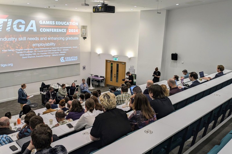 Lecture theatre with people sitting watching a speaker