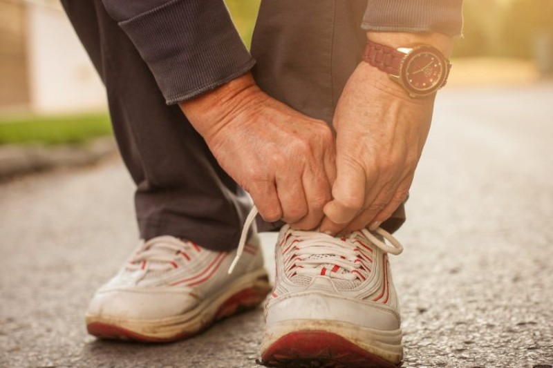 A man tying his shoes