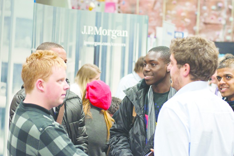 Students at an employer stand at a career fair
