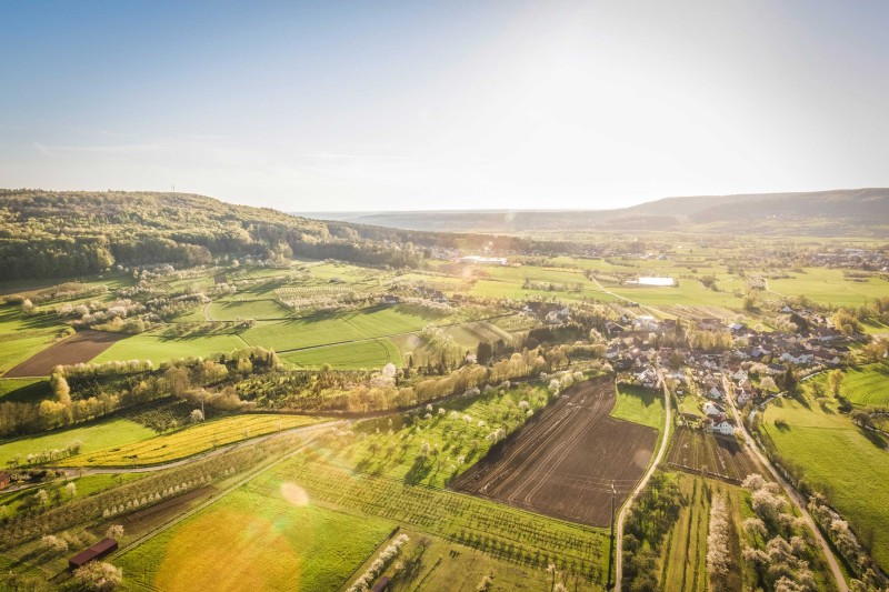 An aerial image of a rural landscape with fields and buildings 