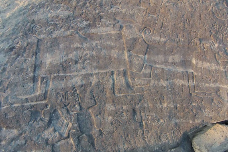 Several carvings and engravings of different shapes on a rock Several carvings and engravings of different shapes on a rock