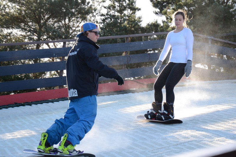 BU student with snowboarding instructor