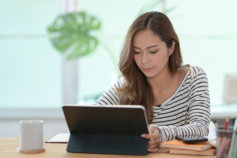 Student using tablet at desk 