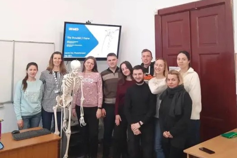 Lauren and a group of physio students from Ukraine, looking at the camera, smiling
